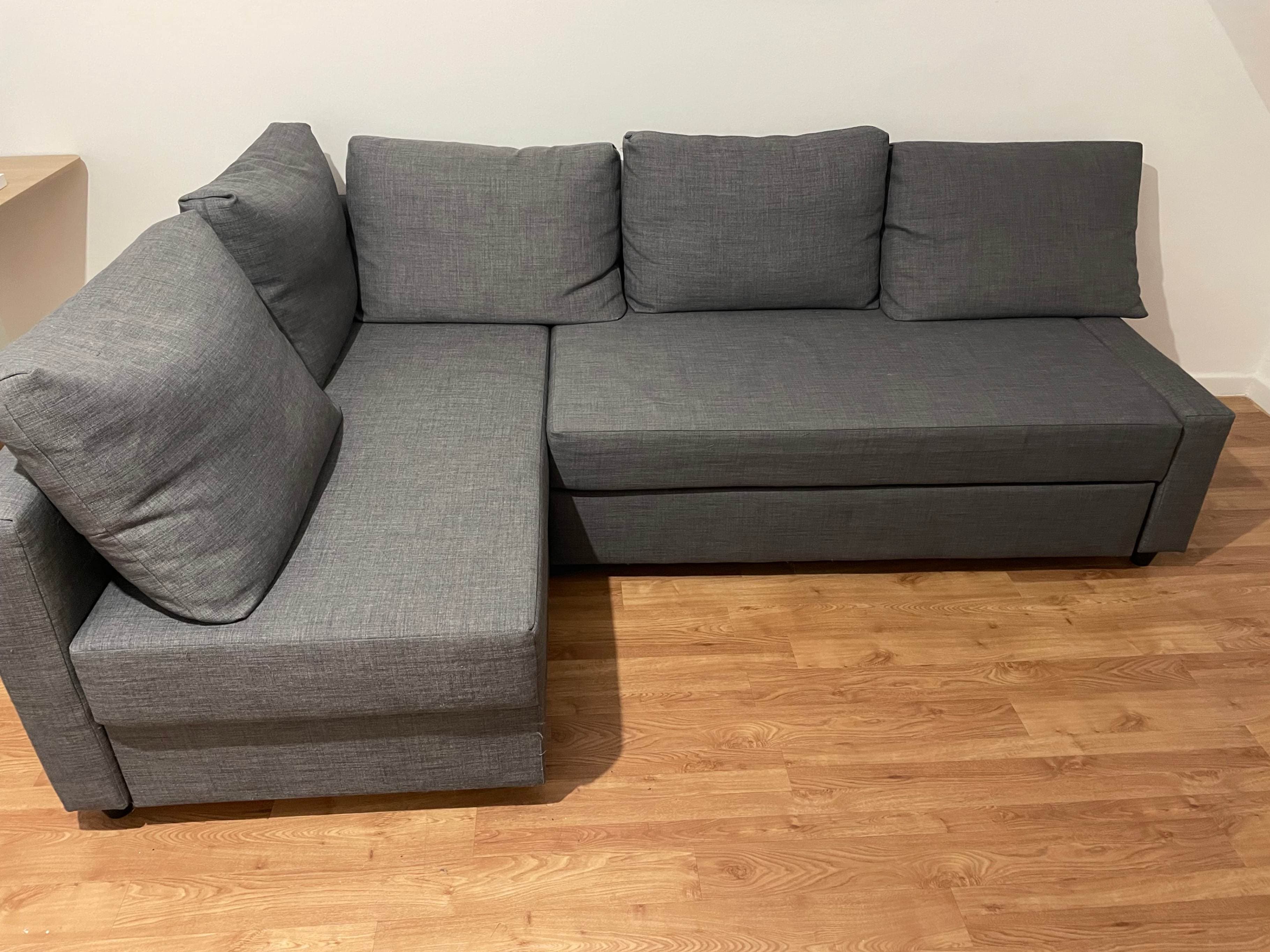 FRIHETEN corner sofa-bed with storage, with extra back cushions/Skiftebo dark grey